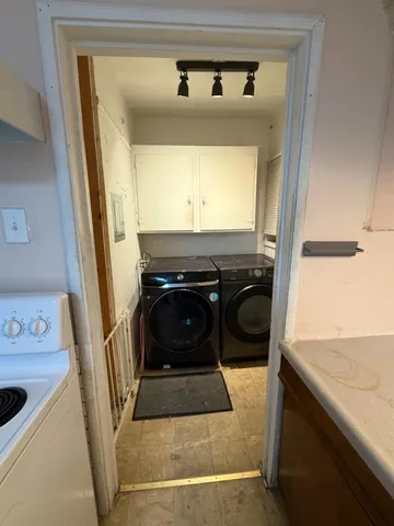 a utility room with a sink a washer and dryer