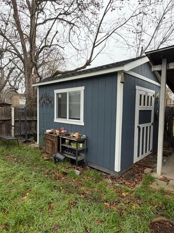 a backyard of a house with yard fire pit and outdoor seating