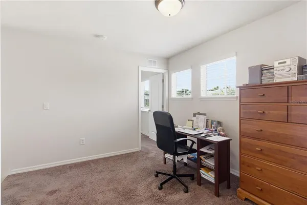 a white toilet sitting next to a white wall