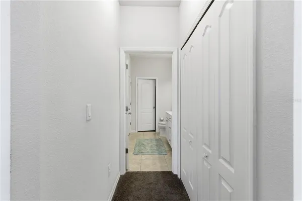 a bedroom with a bed chandelier and a window