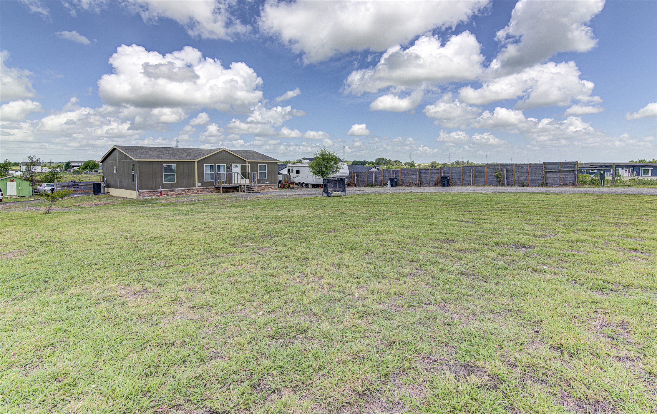 445 Rancho Linda Drive Lockhart, TX 78644 - Photo 5 of 26 A spacious lot provides ample room for outdoor activities, while the well-maintained structure awaits new occupants.