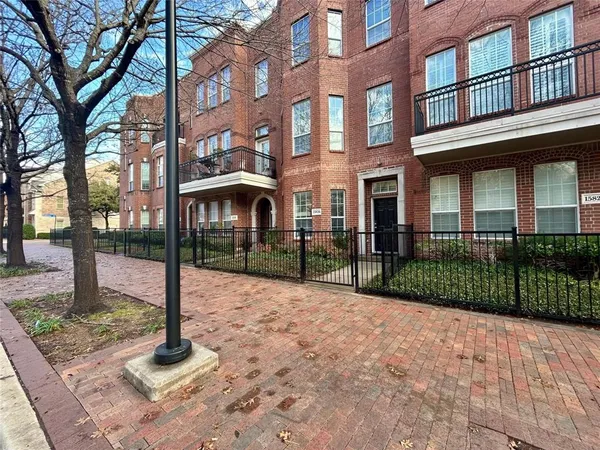 a view of a brick building next to a yard
