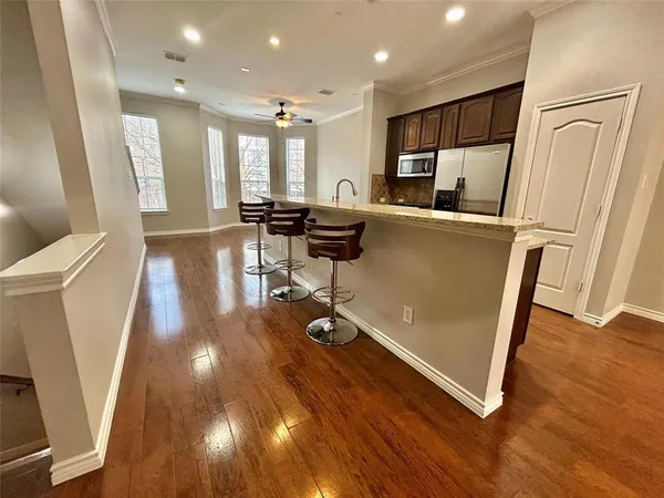 a living room with wooden floor and furniture