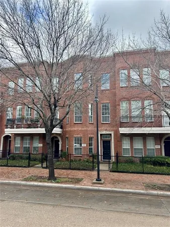 a view of a brick building next to a road