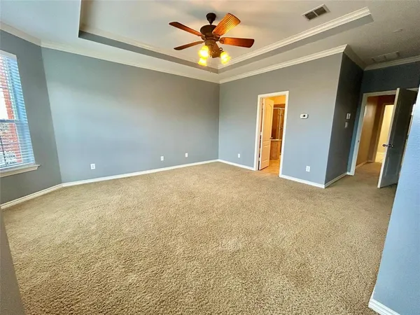 en view of a livingroom with a ceiling fan and window
