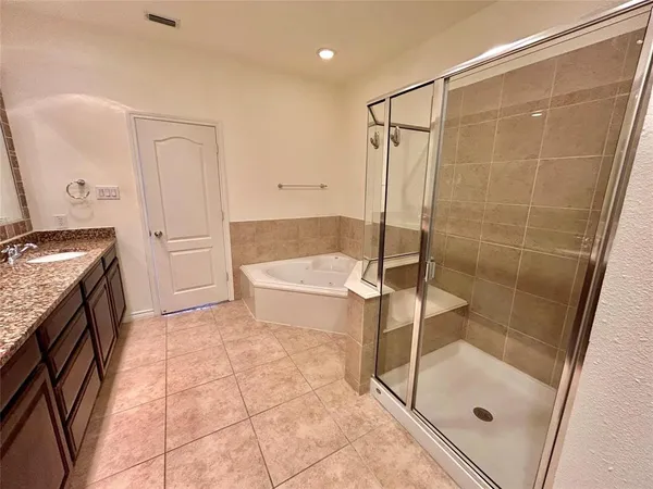a bathroom with a granite countertop sink a toilet and shower
