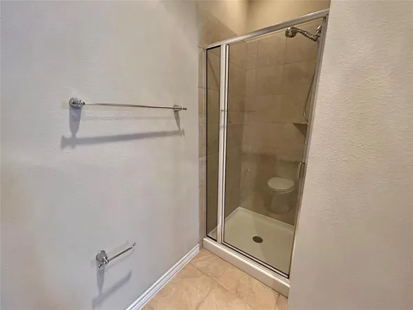a bathroom with a glass shower door