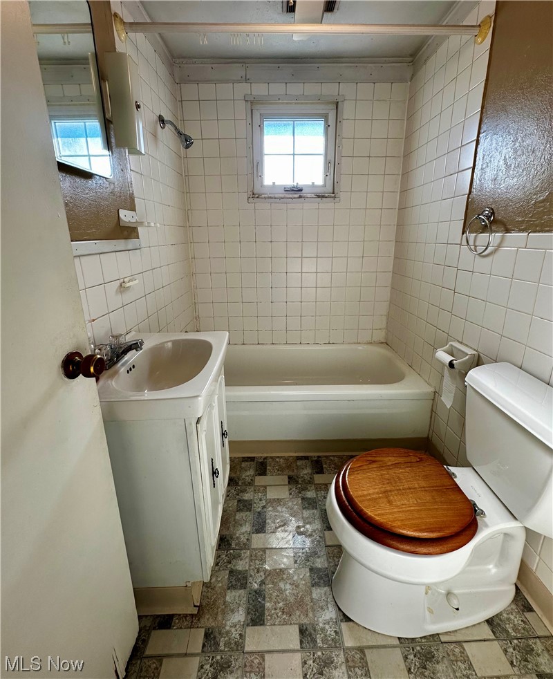 50267 Carroll Road Calcutta, OH 43920 - Photo 14 of 21 Full bathroom with tiled shower / bath combo, vanity, and tile floors