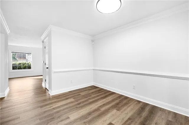 a view of a room with wooden floor