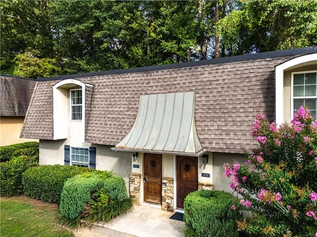 a front view of a house with garden