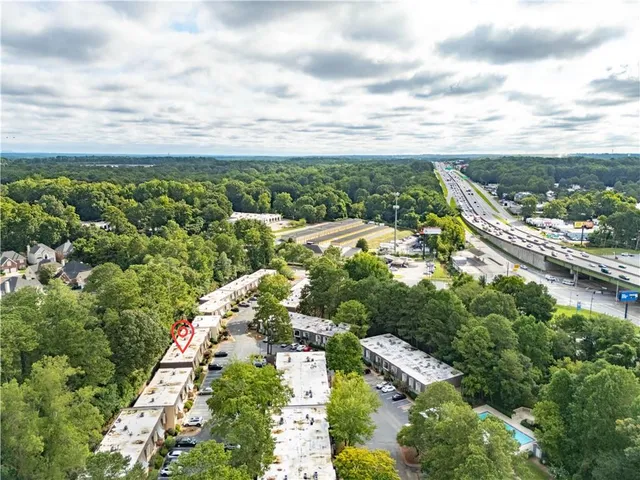 a view of a city with lush green forest