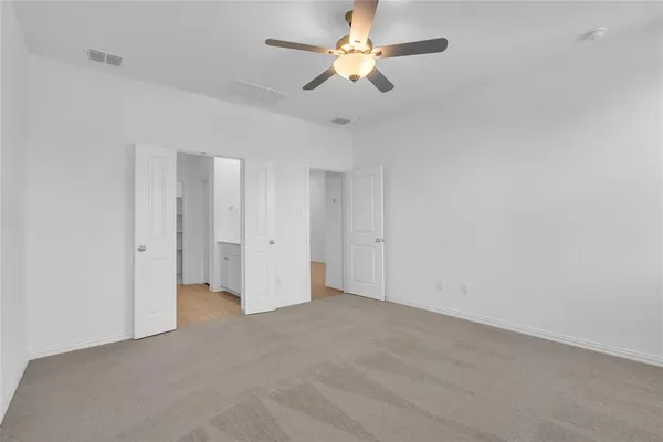 an empty room with a ceiling fan and a ceiling fan