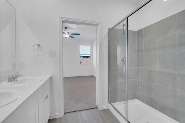 a bathroom with a bathtub shower sink vanity and a mirror