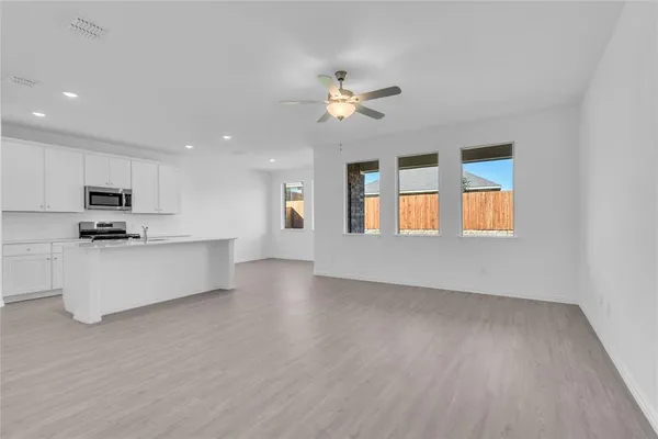 a view of kitchen with closet and wooden floor