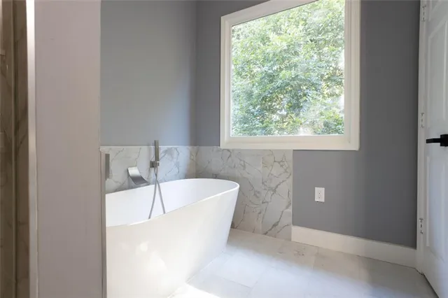 a bathroom with a bathtub and window