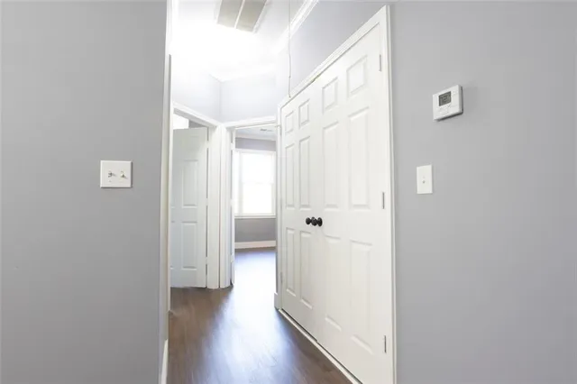 a view of a hallway with wooden floor
