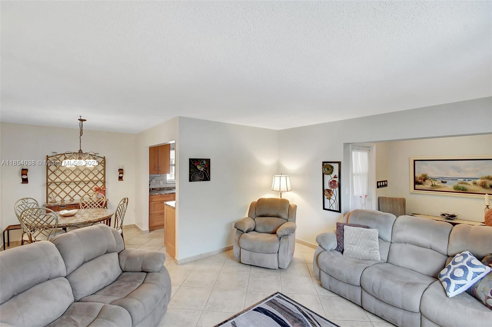 415 Northeast 2nd Street, Unit 201 Hallandale Beach, FL 33009 - Photo 12 of 34 a living room with furniture and a wooden floor