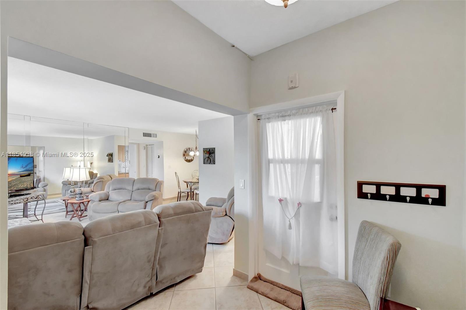 415 Northeast 2nd Street, Unit 201 Hallandale Beach, FL 33009 - Photo 14 of 34 a living room with furniture and a window