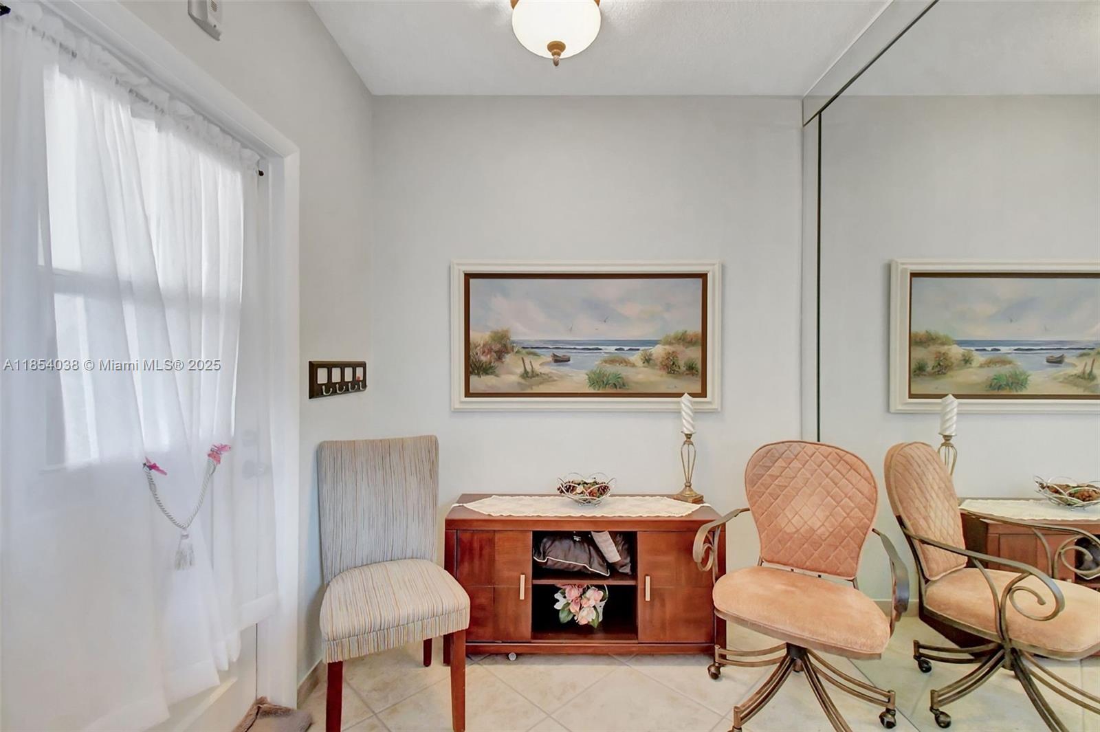 415 Northeast 2nd Street, Unit 201 Hallandale Beach, FL 33009 - Photo 15 of 34 a living room with furniture and a fireplace