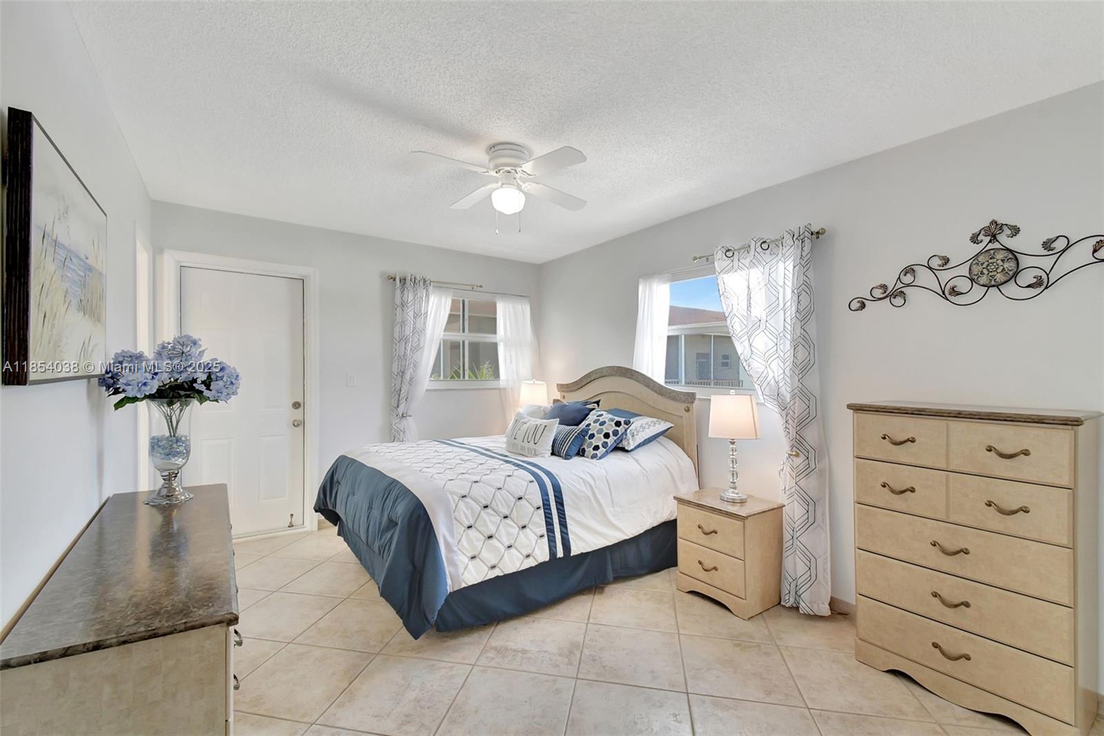 415 Northeast 2nd Street, Unit 201 Hallandale Beach, FL 33009 - Photo 18 of 34 a bedroom with a bed and a dresser