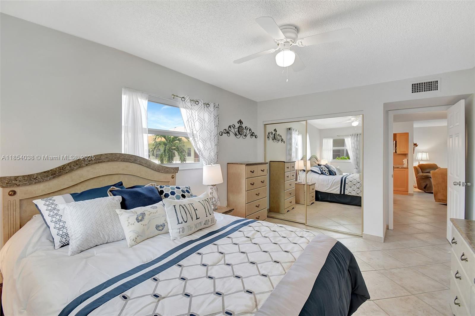 415 Northeast 2nd Street, Unit 201 Hallandale Beach, FL 33009 - Photo 19 of 34 a living room with a bed furniture and a mirror
