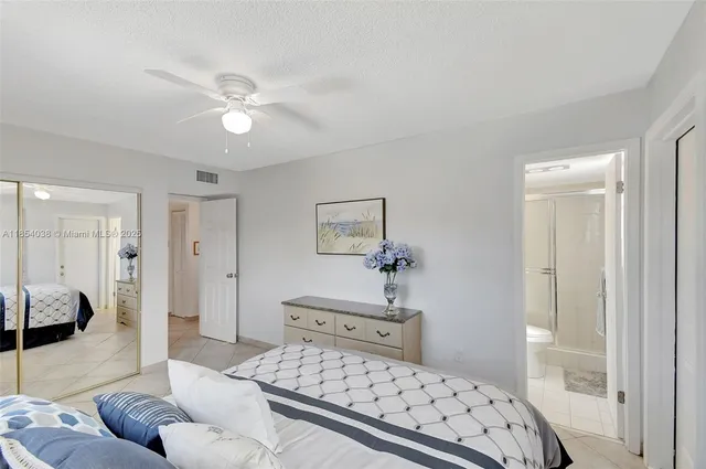 a bedroom with a large bed and a couch