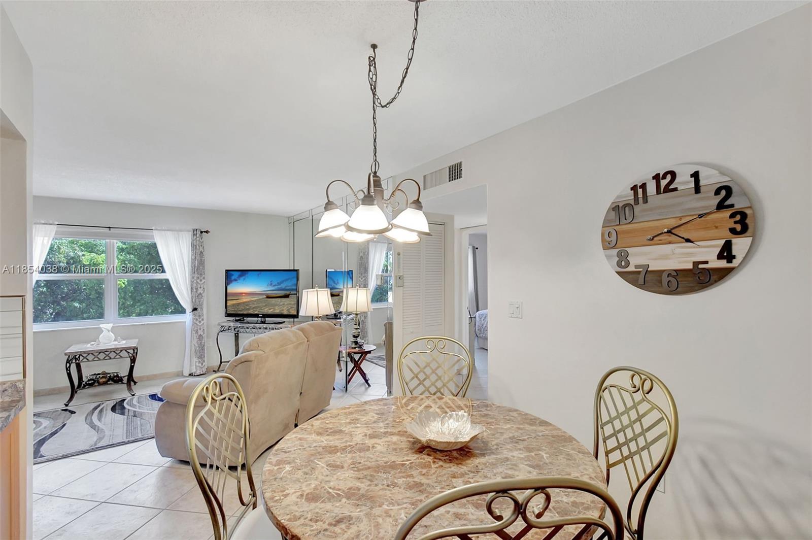 415 Northeast 2nd Street, Unit 201 Hallandale Beach, FL 33009 - Photo 7 of 34 a view of a dining room with furniture window and outside view
