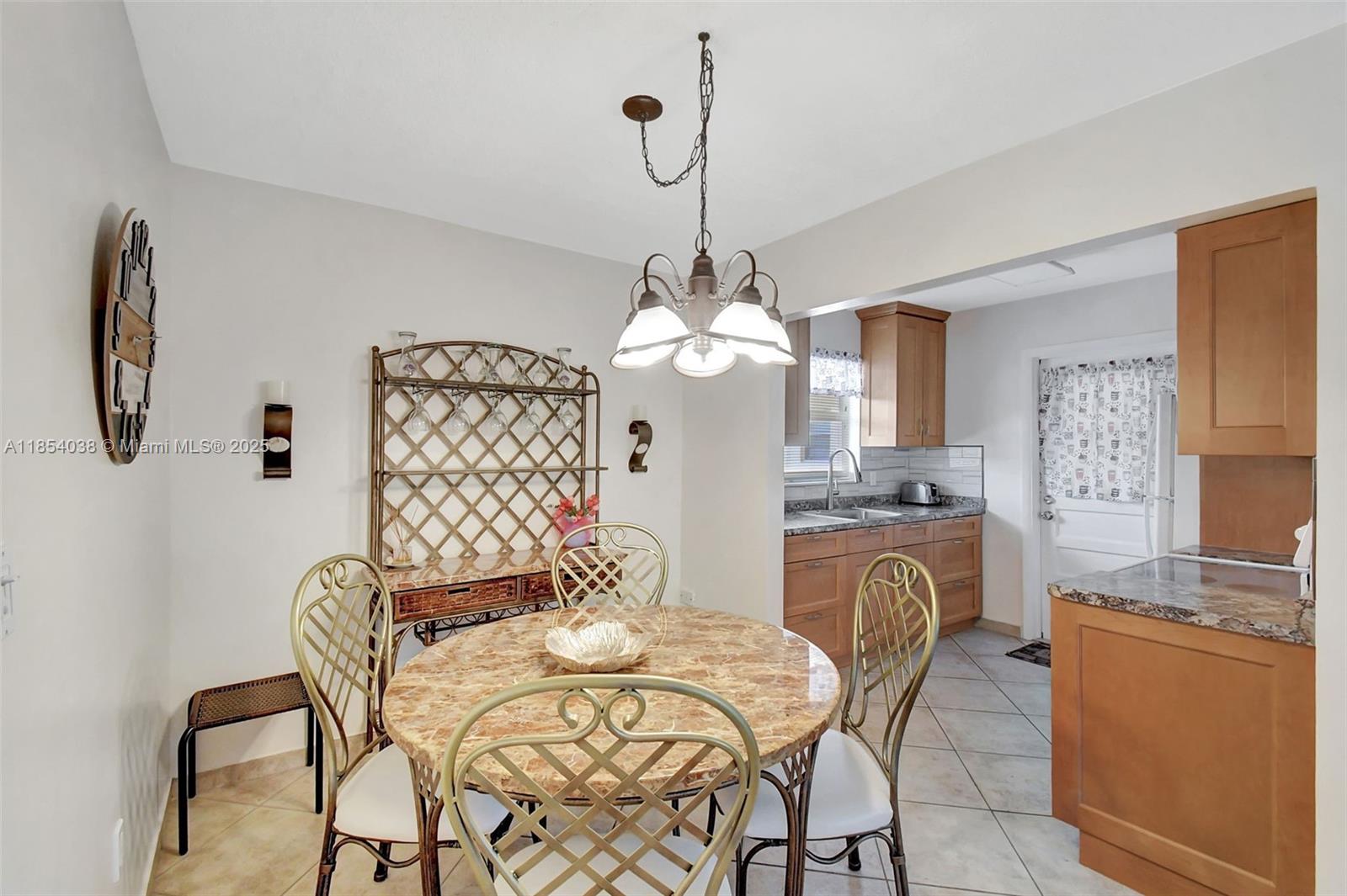 415 Northeast 2nd Street, Unit 201 Hallandale Beach, FL 33009 - Photo 9 of 34 a dining room with furniture and window