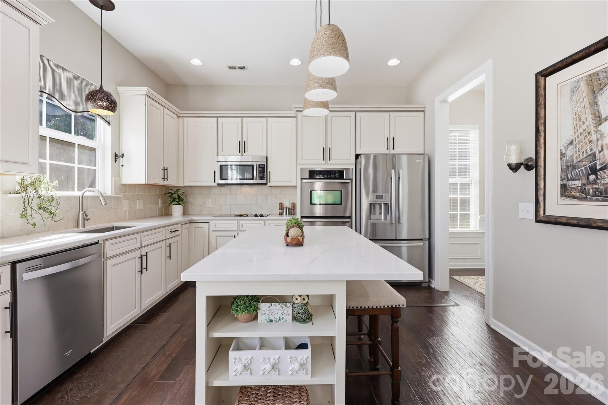 1210 Gold Rush Court Fort Mill, SC 29708 - Photo 12 of 39 a kitchen with stainless steel appliances granite countertop a refrigerator a sink dishwasher a stove and white cabinets with wooden floor