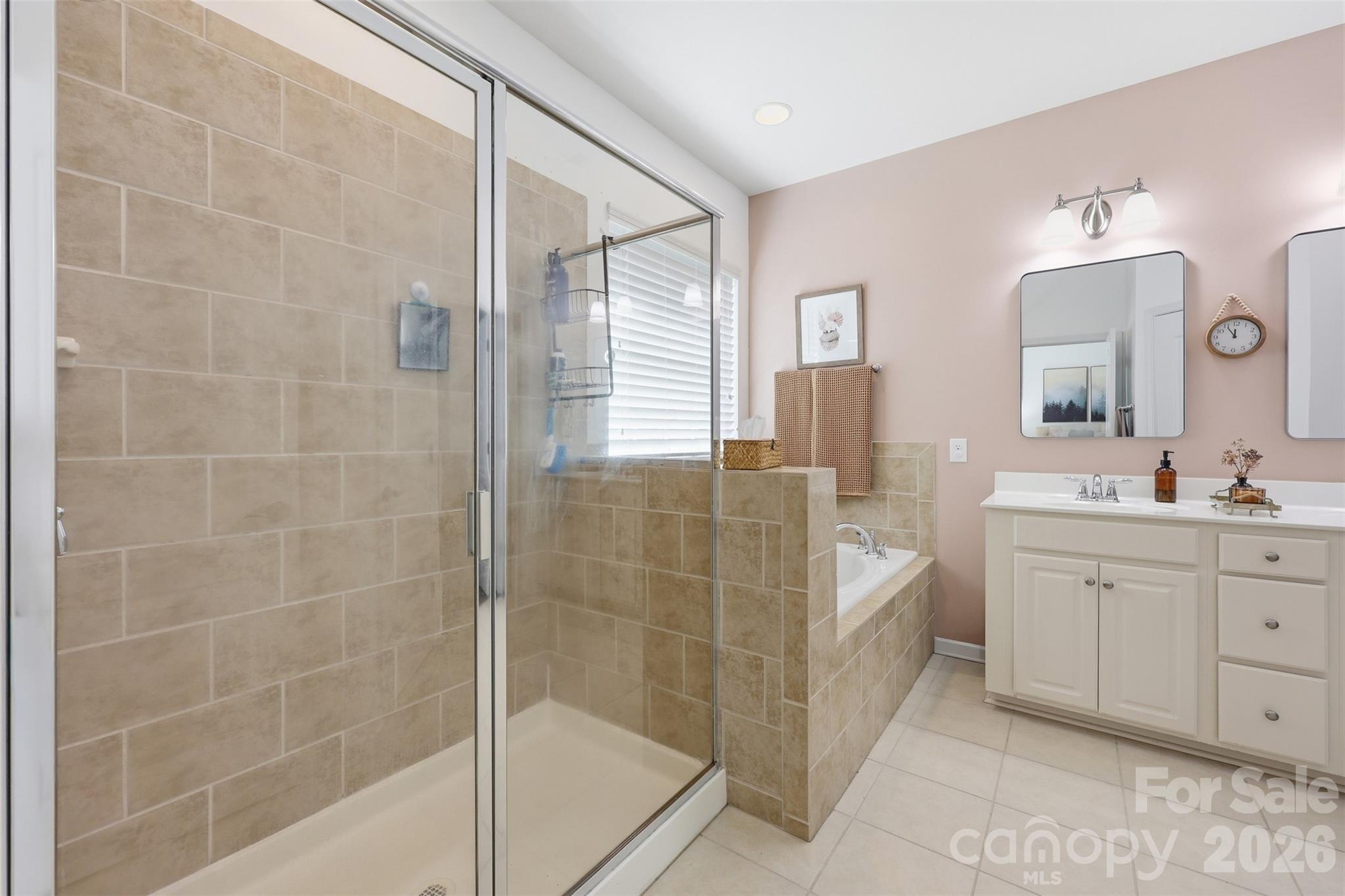 1210 Gold Rush Court Fort Mill, SC 29708 - Photo 16 of 39 a bathroom with a double vanity sink a mirror and a shower
