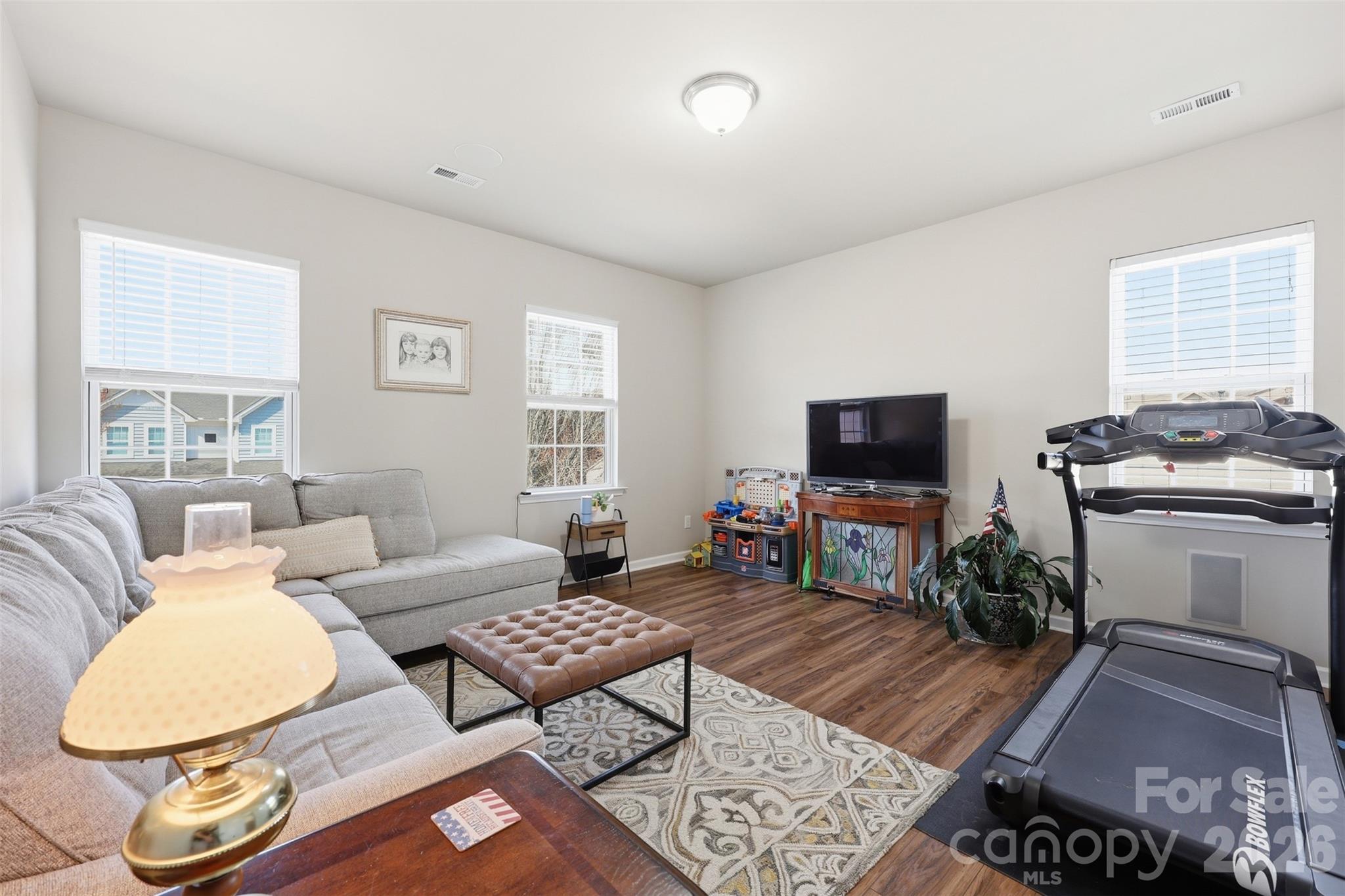 1210 Gold Rush Court Fort Mill, SC 29708 - Photo 18 of 39 a living room with furniture a flat screen tv and a window