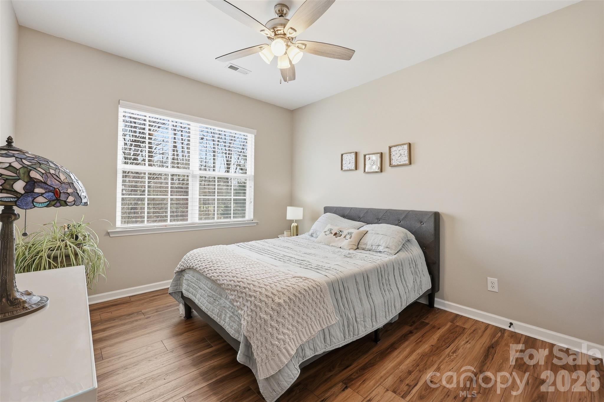 1210 Gold Rush Court Fort Mill, SC 29708 - Photo 19 of 39 a bedroom with a bed and wooden floor