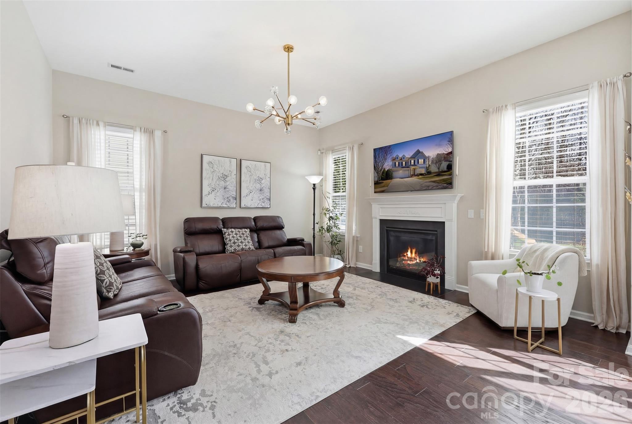 1210 Gold Rush Court Fort Mill, SC 29708 - Photo 9 of 39 a living room with furniture a fireplace and a table