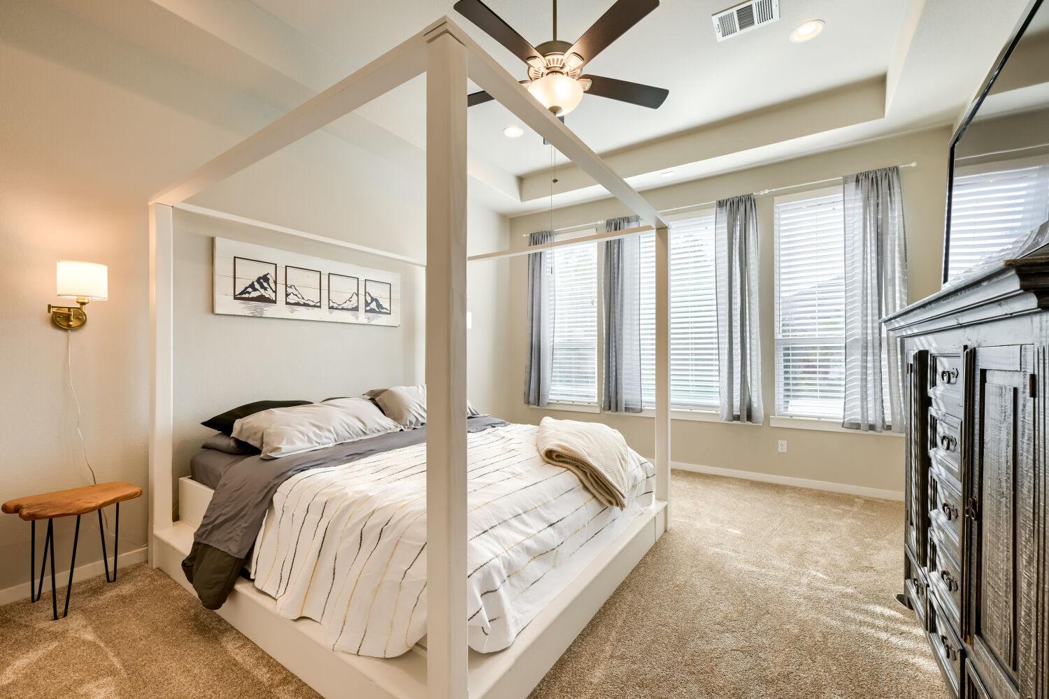 621 Rancho Sienna Loop Georgetown, TX 78628 - Photo 13 of 28 A tranquil primary bedroom suite with plush carpeting and natural light from large windows.
