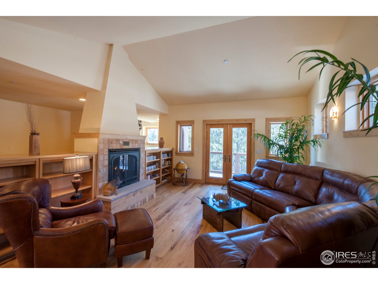 4900 Ridge Road Boulder, CO 80302 - Photo 2 of 38 a living room with furniture a fireplace and a flat screen tv