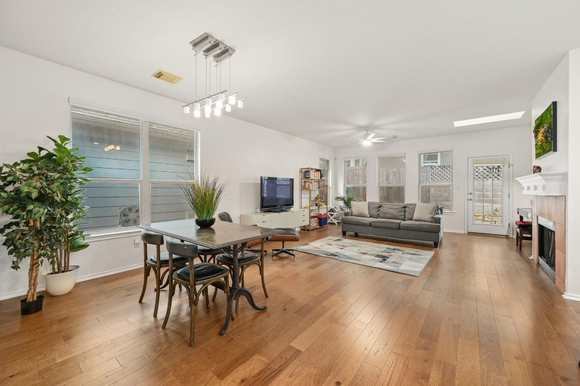 2721 Kinney Oaks Court Austin, TX 78704 - Photo 11 of 28 a living room with furniture dining table a potted plant and a fireplace