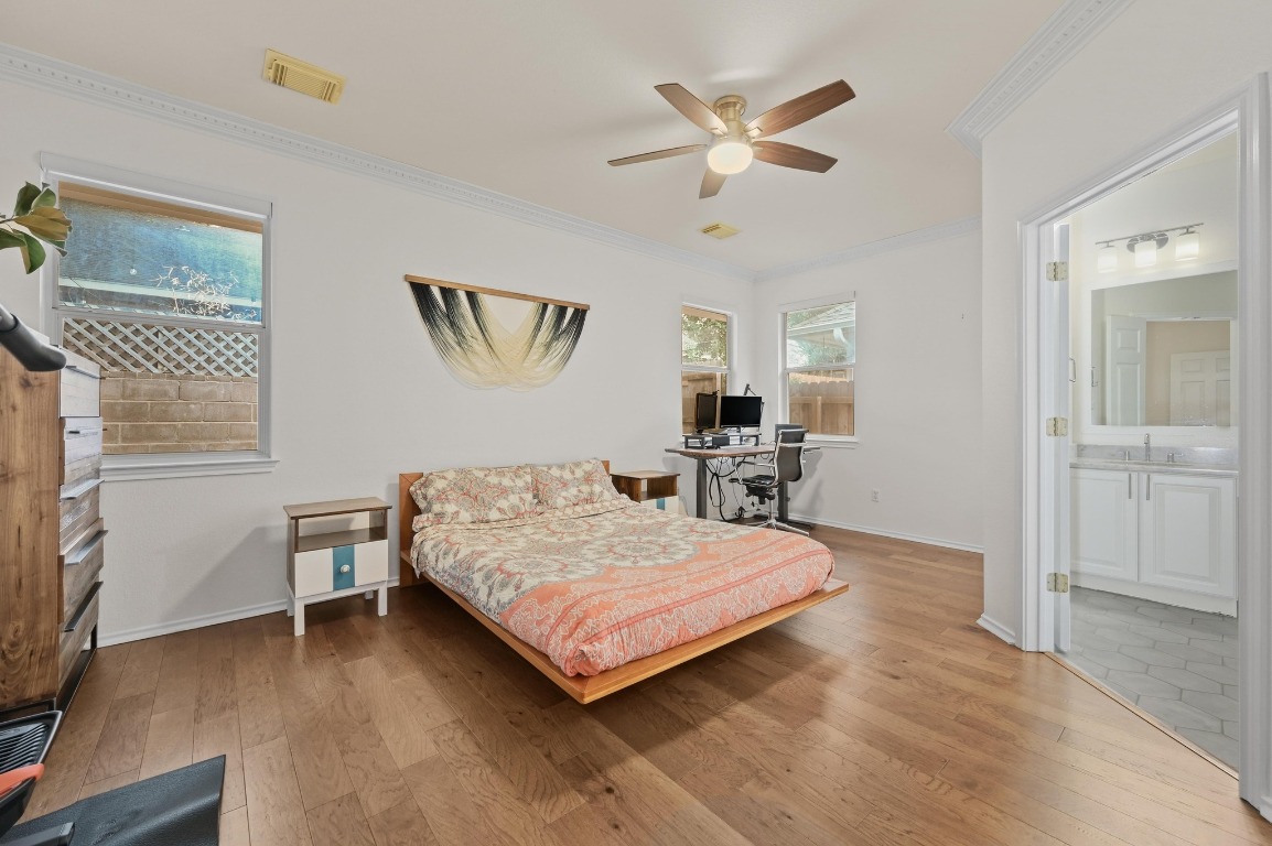 2721 Kinney Oaks Court Austin, TX 78704 - Photo 15 of 28 a bedroom with a bed and a chandelier