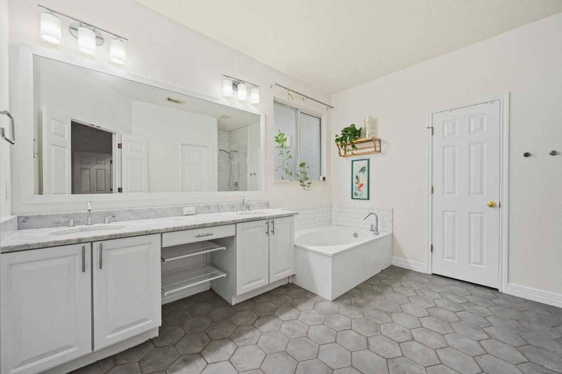 2721 Kinney Oaks Court Austin, TX 78704 - Photo 16 of 28 a spacious bathroom with a double vanity sink mirror and bathtub