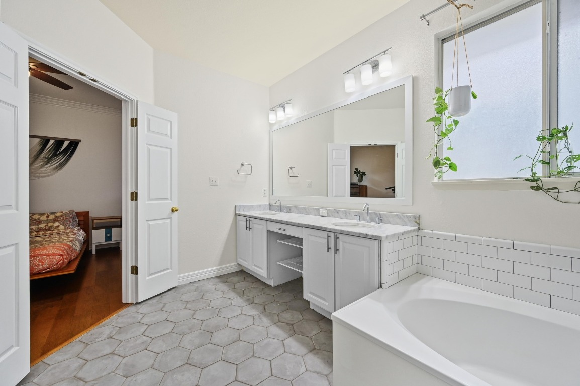 2721 Kinney Oaks Court Austin, TX 78704 - Photo 17 of 28 a bathroom with a tub sink and mirror
