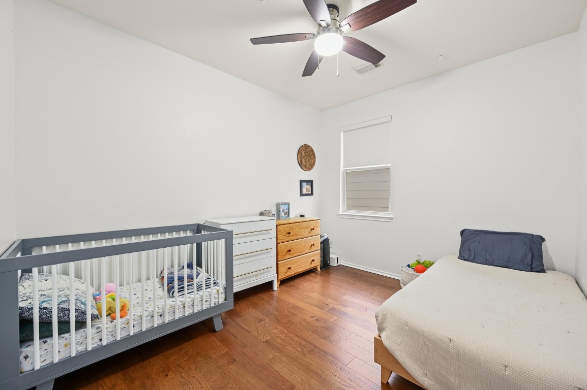 2721 Kinney Oaks Court Austin, TX 78704 - Photo 20 of 28 a bedroom with furniture and wooden floor