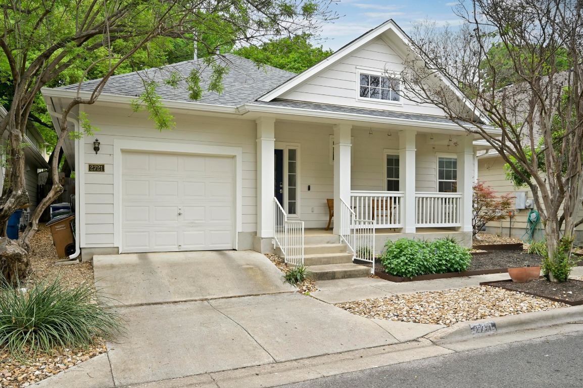 2721 Kinney Oaks Court Austin, TX 78704 - Photo 25 of 28 a view of a white house with a potted plant and a large tree
