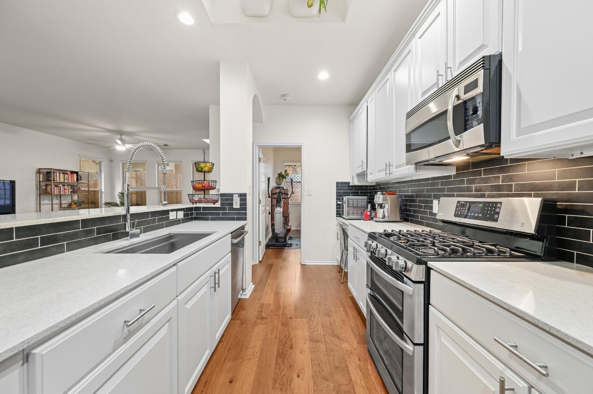 2721 Kinney Oaks Court Austin, TX 78704 - Photo 6 of 28 a kitchen with stainless steel appliances granite countertop a stove and a sink