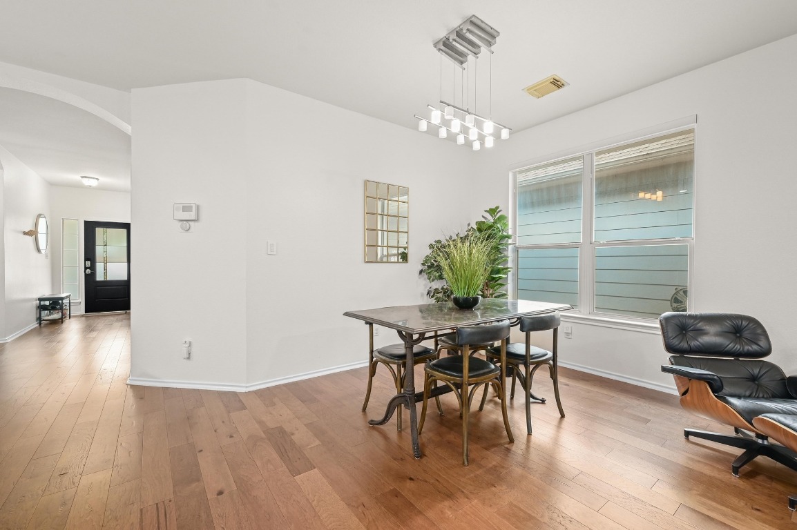 2721 Kinney Oaks Court Austin, TX 78704 - Photo 10 of 28 a view of a dining room with furniture and wooden floor
