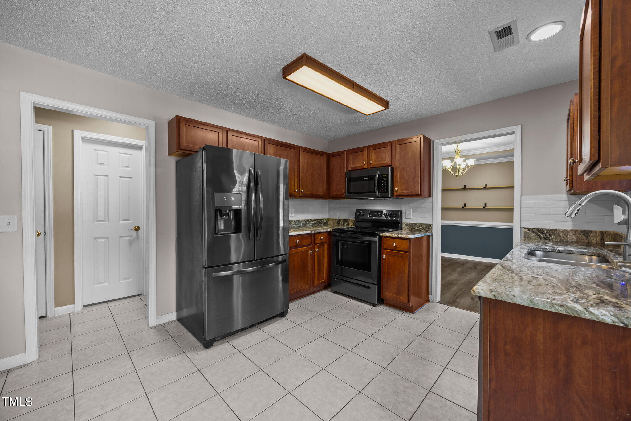 86 Pender Road Spring Lake, NC 28390 - Photo 12 of 35 a kitchen with stainless steel appliances granite countertop a refrigerator oven a sink and dishwasher