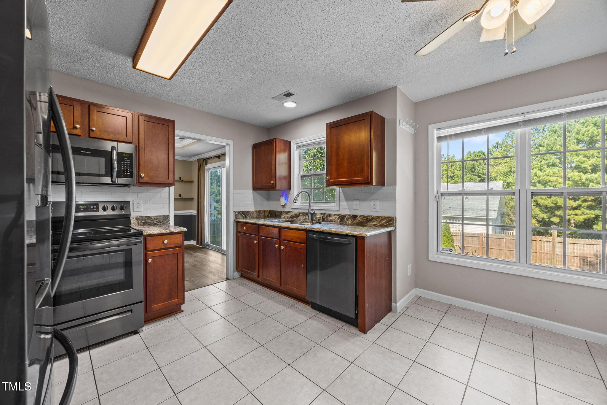 86 Pender Road Spring Lake, NC 28390 - Photo 13 of 35 a kitchen with stainless steel appliances kitchen island granite countertop a stove refrigerator and cabinets