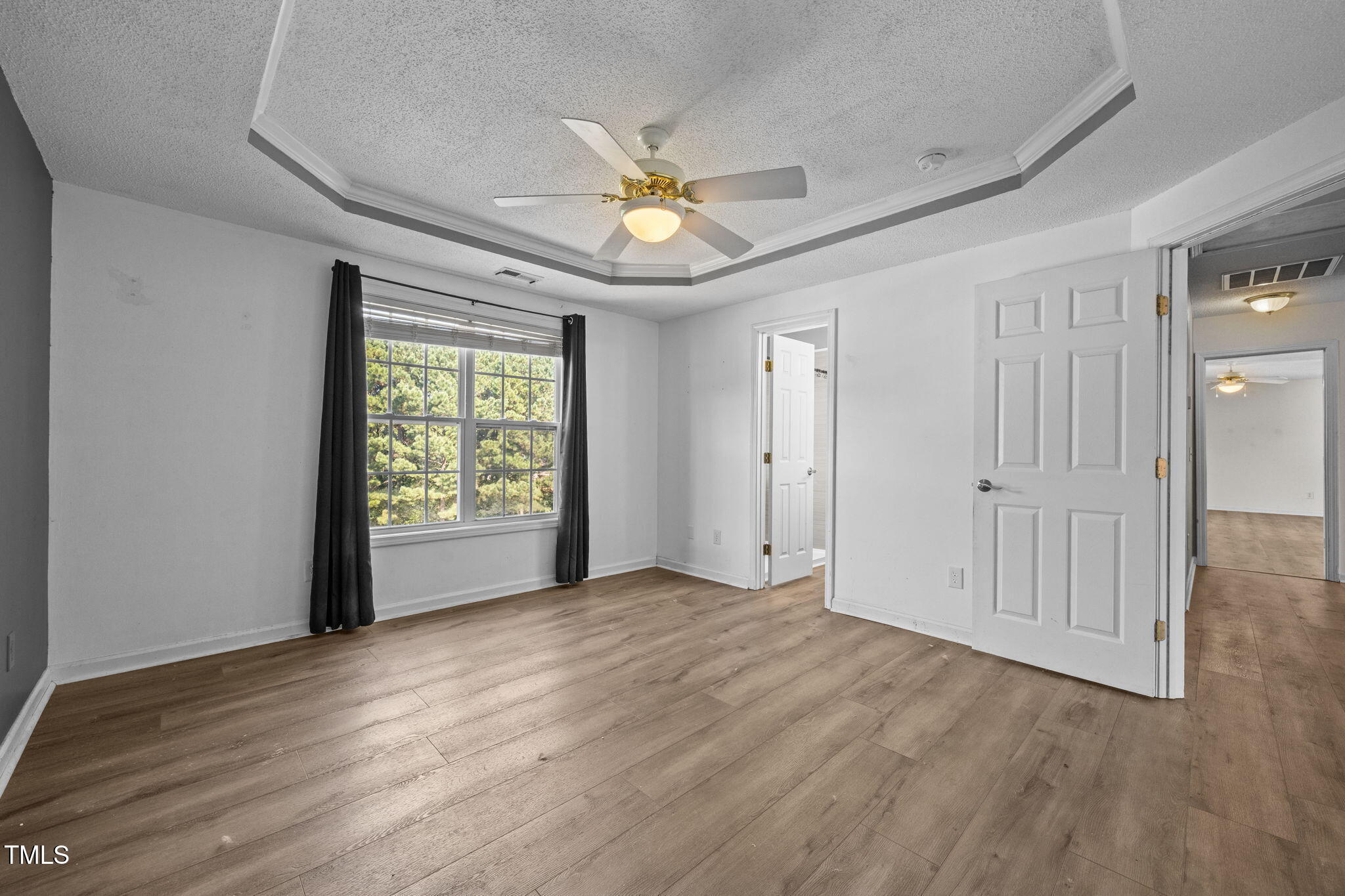86 Pender Road Spring Lake, NC 28390 - Photo 18 of 35 a view of an empty room with window and wooden floor