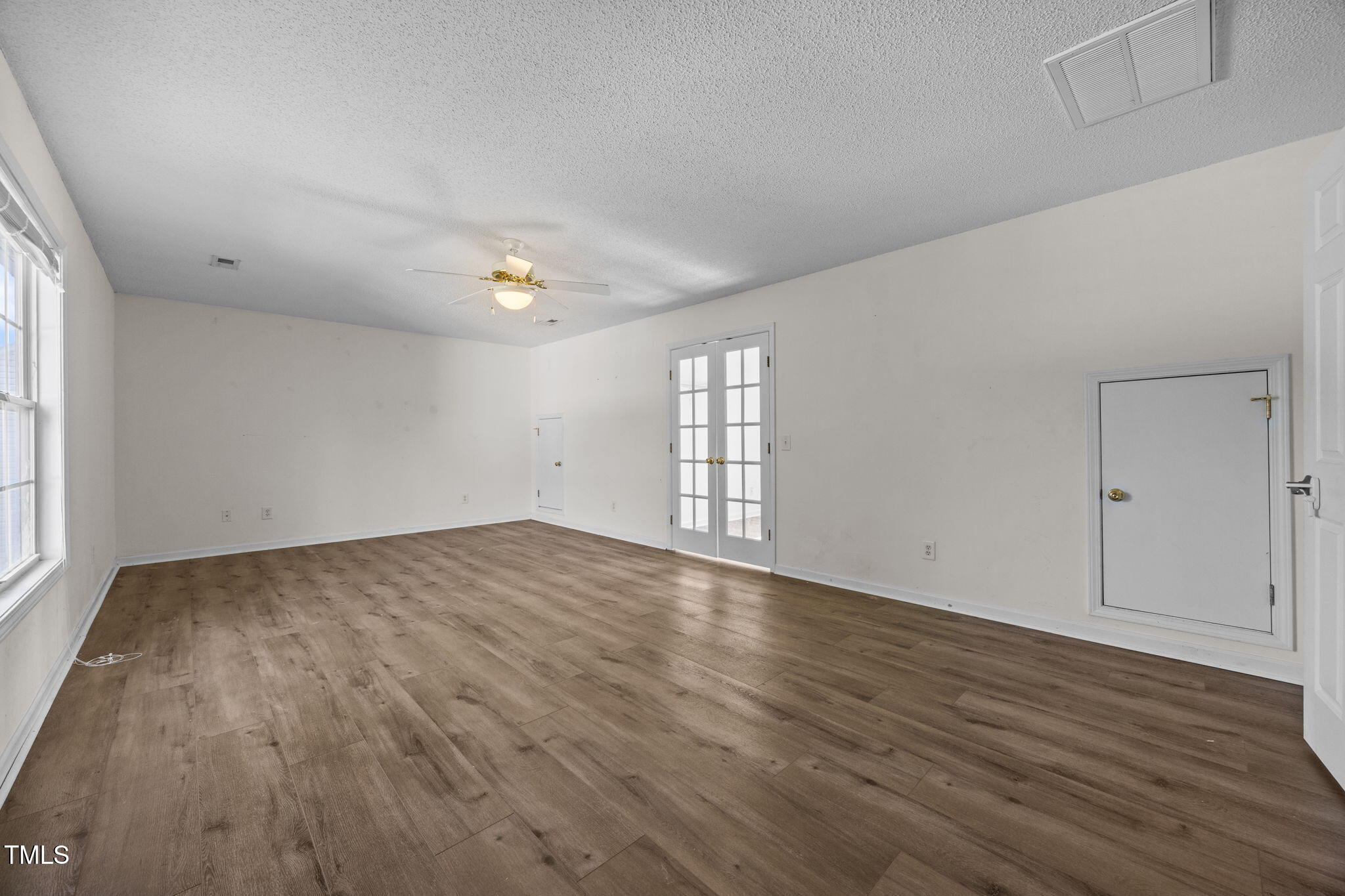 86 Pender Road Spring Lake, NC 28390 - Photo 22 of 35 an empty room with wooden floor and windows