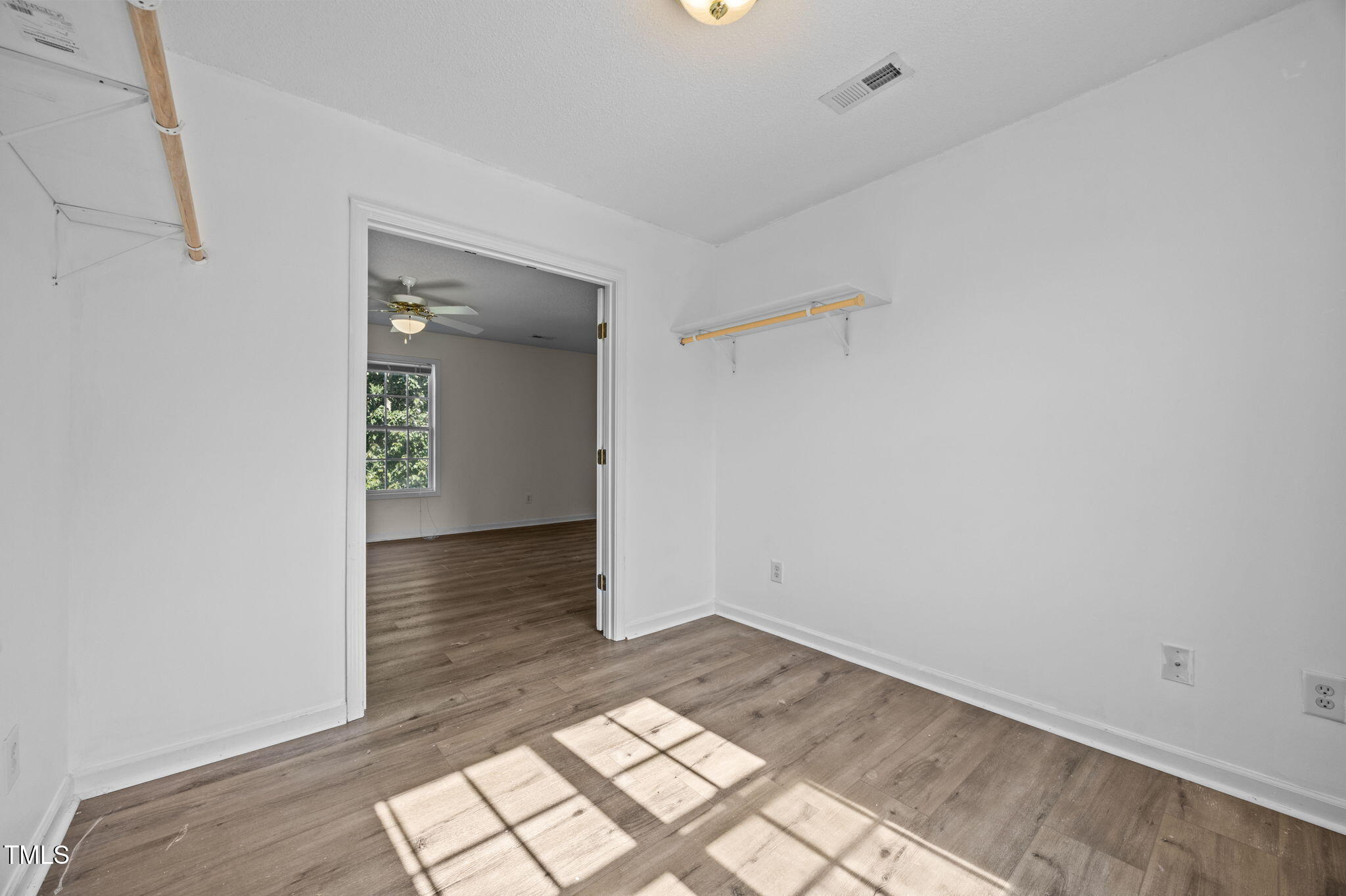 86 Pender Road Spring Lake, NC 28390 - Photo 26 of 35 an empty room with wooden floor and windows