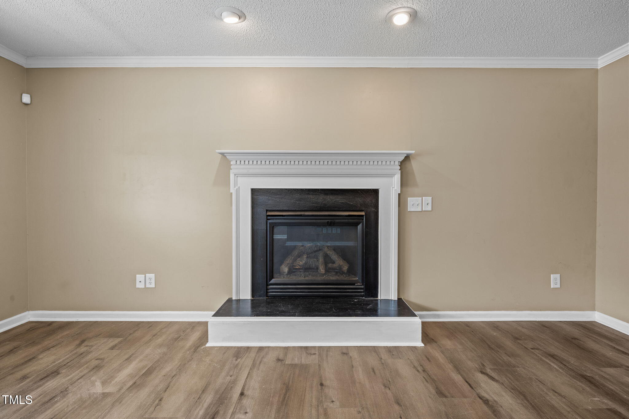 86 Pender Road Spring Lake, NC 28390 - Photo 5 of 35 an empty room with wooden floor and fireplace