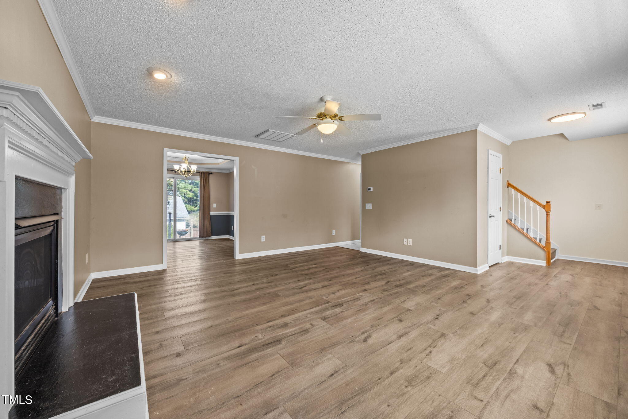 86 Pender Road Spring Lake, NC 28390 - Photo 7 of 35 a view of an empty room with wooden floor and a kitchen